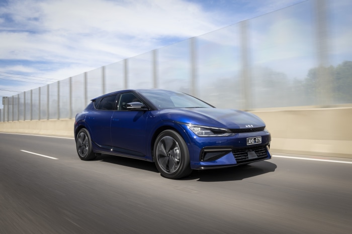 Blue Kia EV6 GT Line electric car driving on road