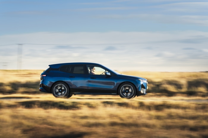 BMW iX xDrive40 Sport SUV driving on a road