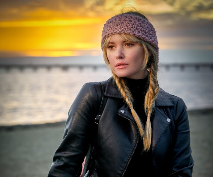 Carla Monaco wearing a leather jacket and headband