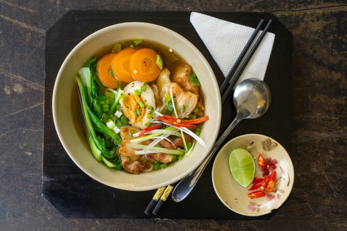 Bowl of Asian noodle soup with pork and egg