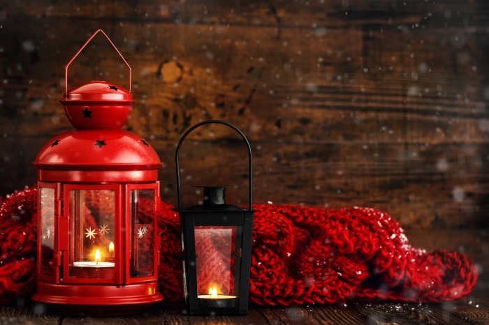 Two lit lanterns and a red scarf