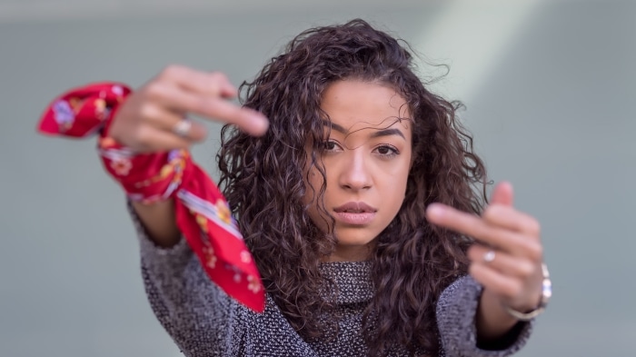 Woman with curly hair and red scarf