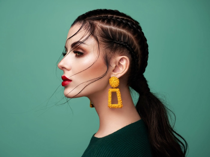 Woman with braided hair and large yellow earrings