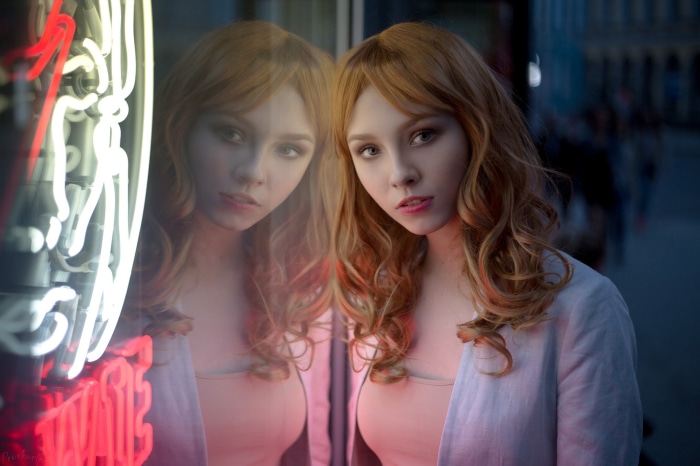 Alice Tarasenko reflected in neon lights