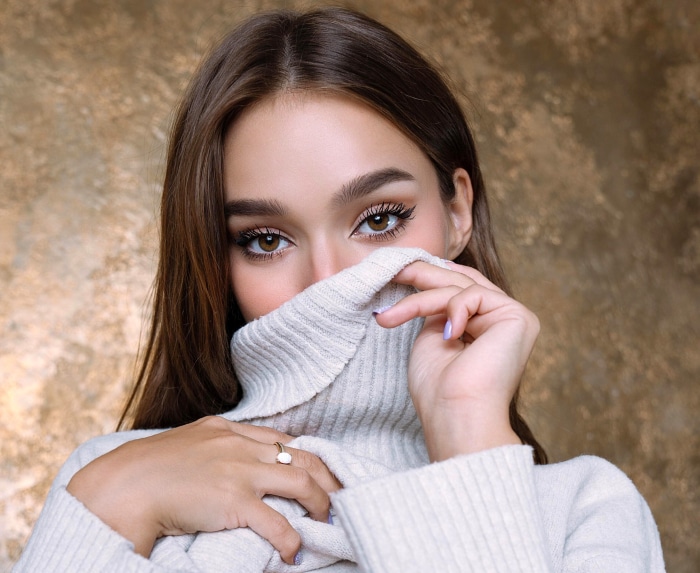 Woman with brown eyes wearing a turtleneck