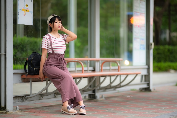 Young Asian woman at bus stop