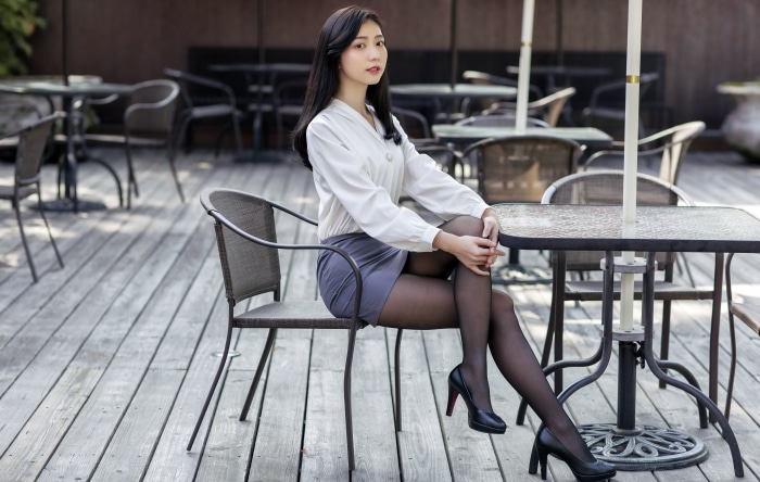 Asian woman with black hair sitting at a table