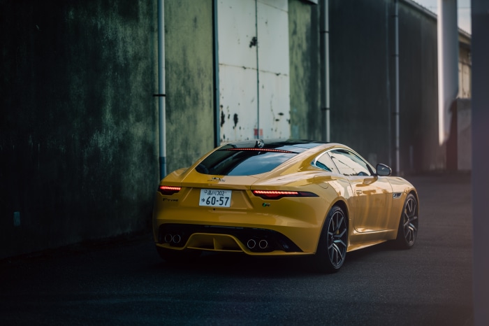 Yellow Jaguar F-Type R Coupe parked outdoors