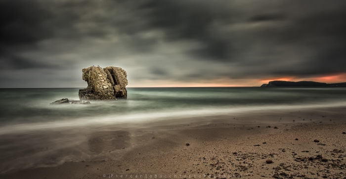 Ancient Spanish Tower on a Beach at Sunset