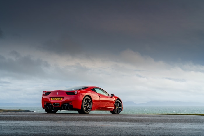 Red Ferrari 458 Italia parked by the sea