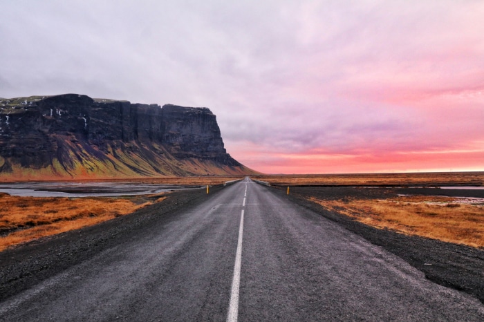 Road through Iceland landscape at sunset