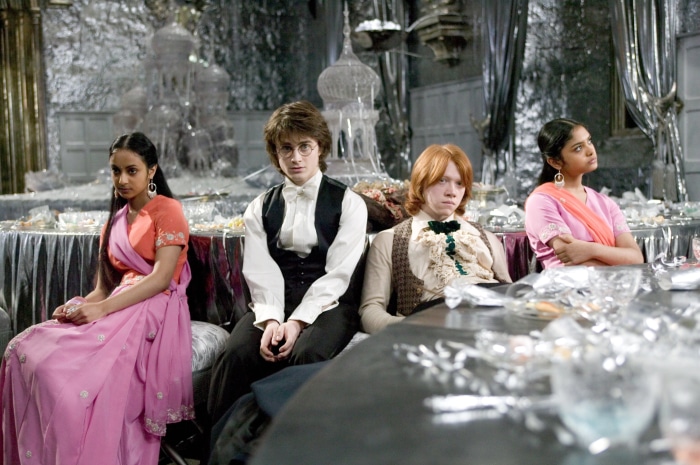 Harry Potter, Ron Weasley, Padma Patil, and Parvati Patil at a formal event