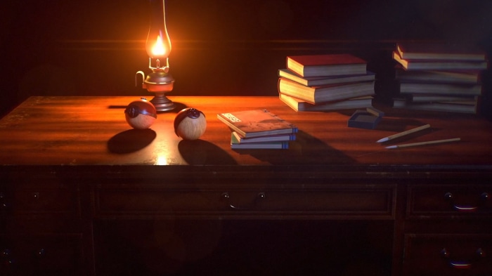 Desk with oil lamp, books, and writing tools
