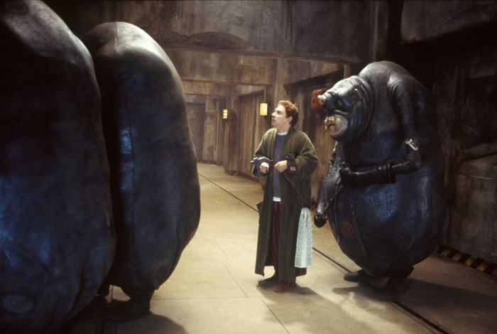 Arthur Dent and a Vogon in a corridor
