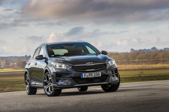 Dark gray Kia XCeed driving on a road