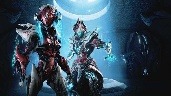 Two Warframe characters in a futuristic chamber