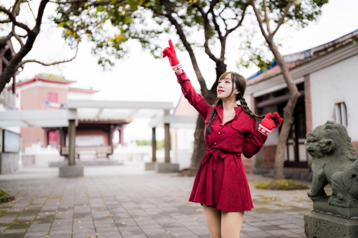 Asian woman in red dress with braids