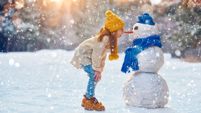Girl and Snowman in Snowy Forest