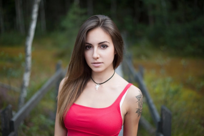 Brunette woman with tattoo in red top