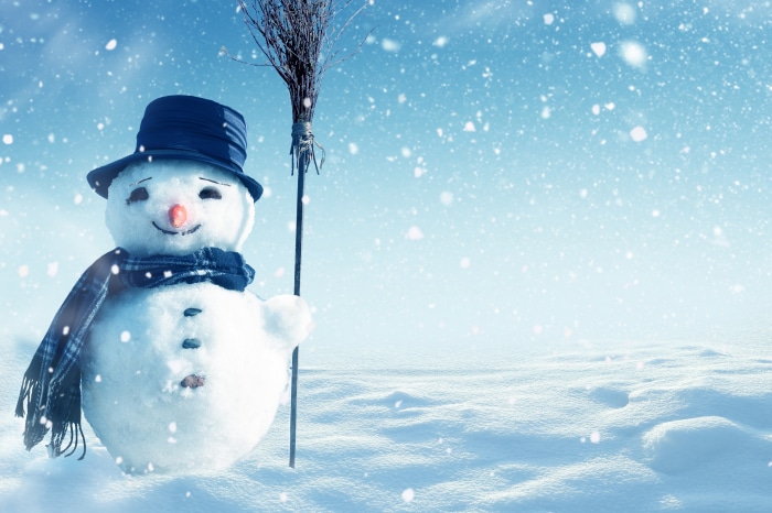 Artistic Snowman with Broom in Snow