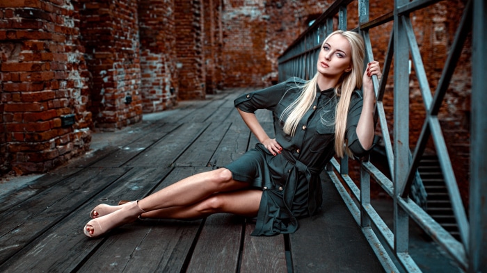 Blonde Model Posing on Wooden Walkway by Brick Wall