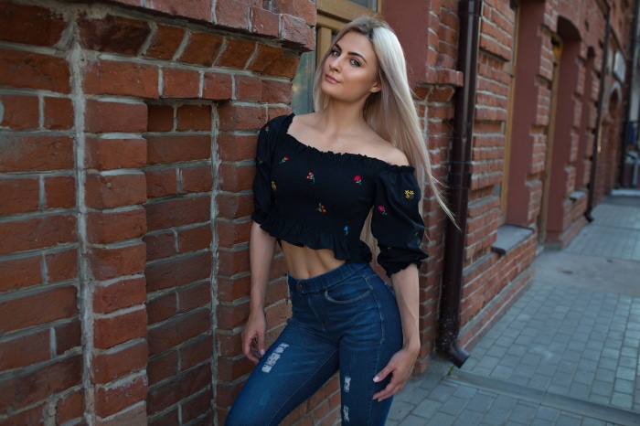 Woman in off-the-shoulder top and jeans