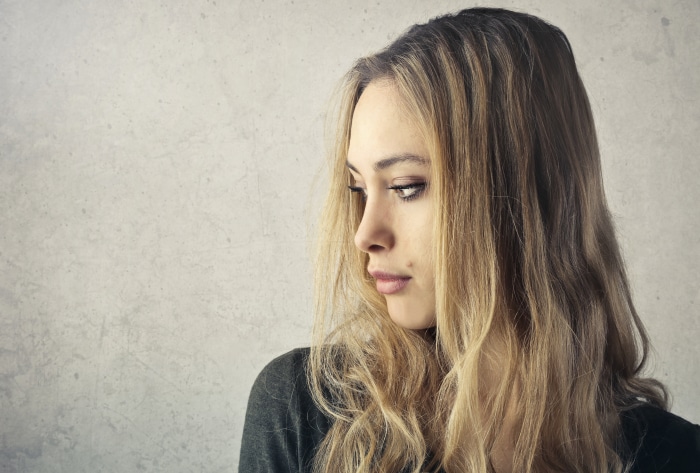 Woman with blonde hair looking down