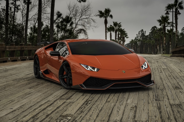 Orange Lamborghini Huracan on a wooden bridge