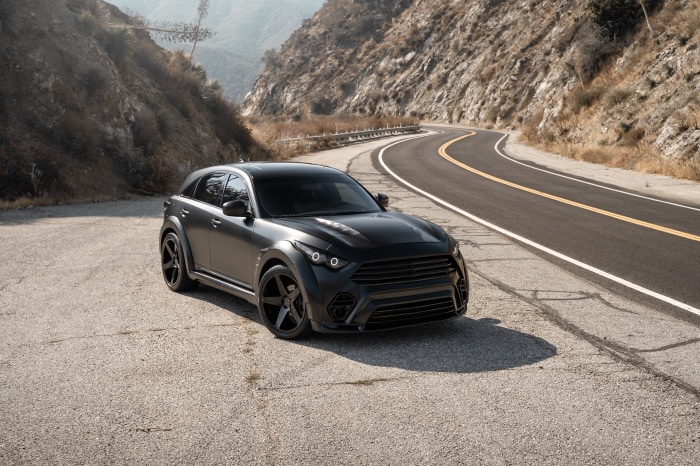 Matte black Infiniti QX70 SUV on a winding mountain road