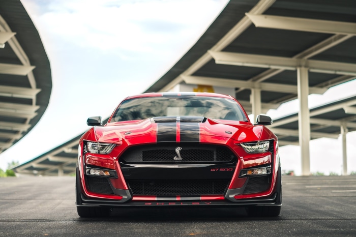Red Ford Mustang Shelby GT500 parked under a canopy