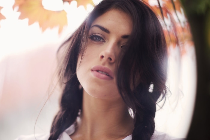 Brunette woman with braided hair outdoors