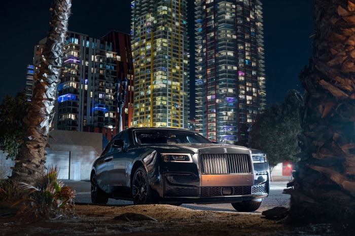 Rolls-Royce Ghost parked at night with city buildings