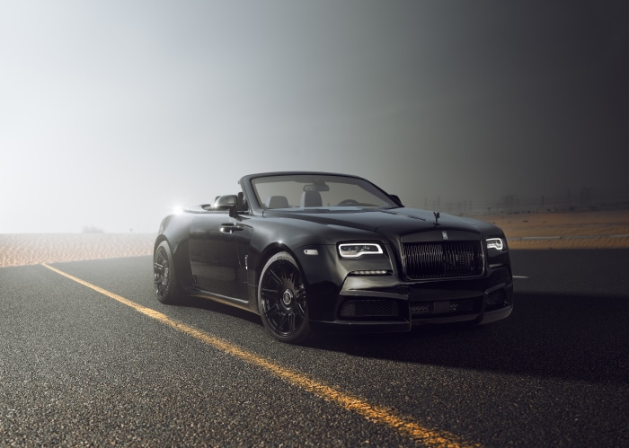 Black Rolls-Royce Dawn convertible on a desert road