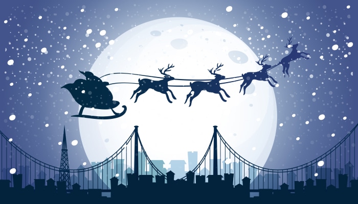 Santa's Sleigh Flying Over City at Night