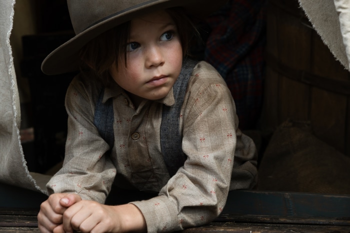 Young boy in hat and suspenders