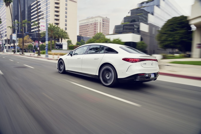White Mercedes-AMG EQS 53 4MATIC driving on city street