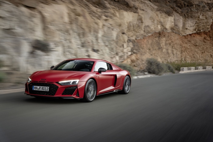 Red Audi R8 V10 driving on a road