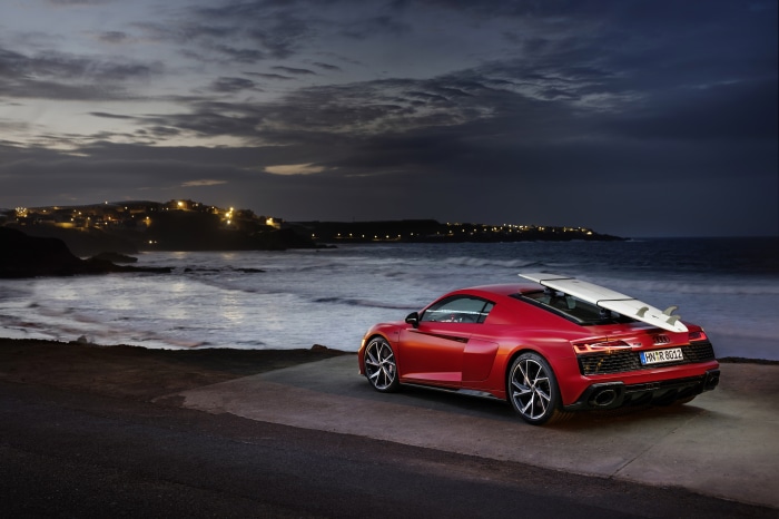 Red Audi R8 V10 with surfboard at dusk