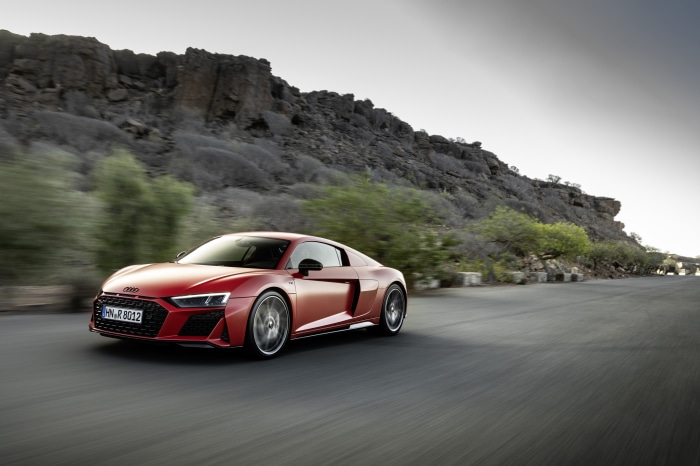 Red Audi R8 V10 driving on a road