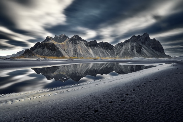 Vestrahorn Mountains reflection on black sand beach, Iceland