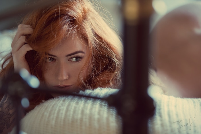 Redhead woman with hand in hair