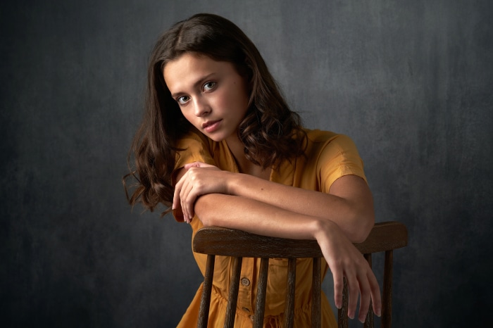 Brunette woman sitting on a chair
