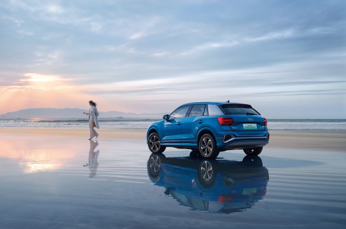 Audi Q2 L e-tron on a beach at sunset
