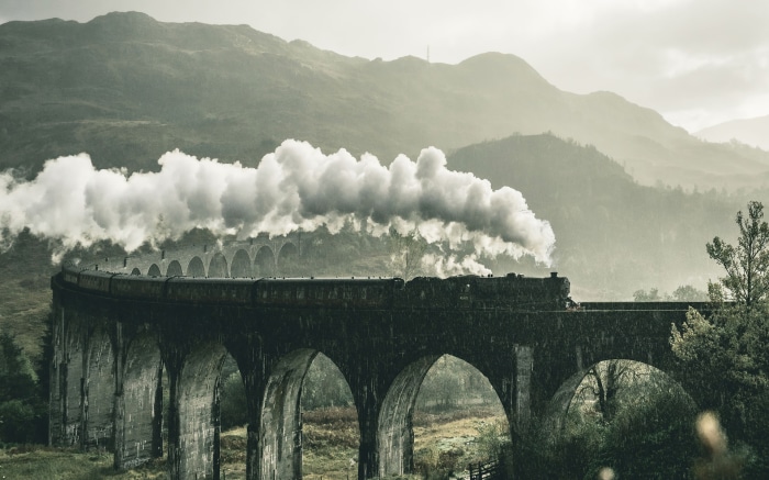 Steam train on a viaduct in the Scottish Highlands