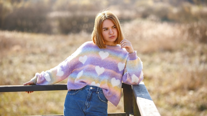 Woman in heart sweater and jeans