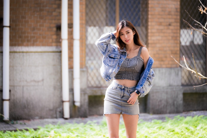 Asian woman in denim jacket and skirt
