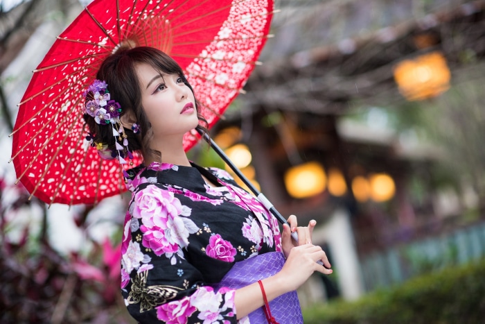Woman in Kimono holding a red umbrella