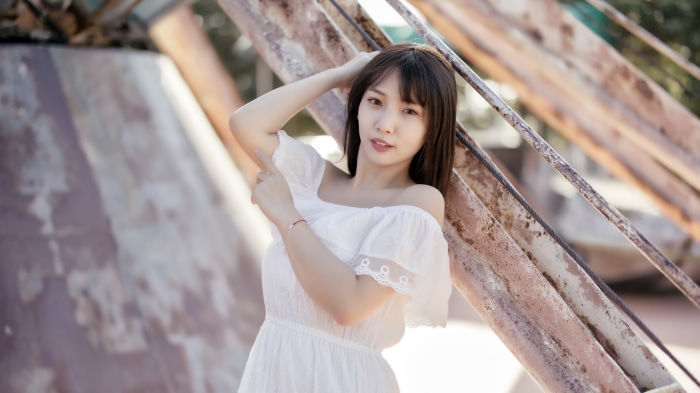 Asian woman in white dress outdoors