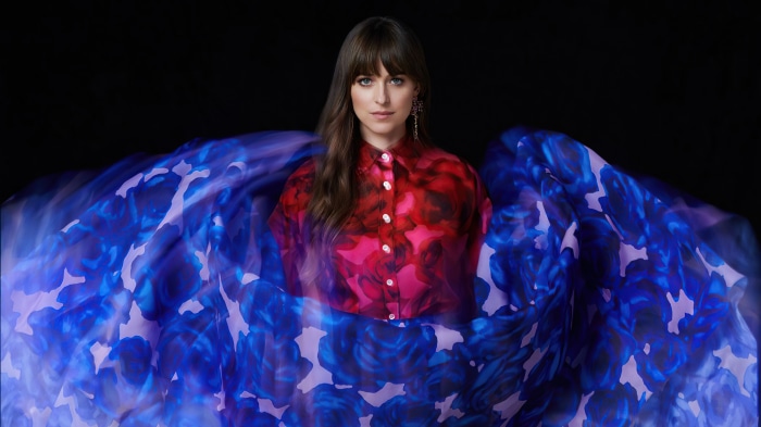 Dakota Johnson in a floral shirt with a blue floral skirt