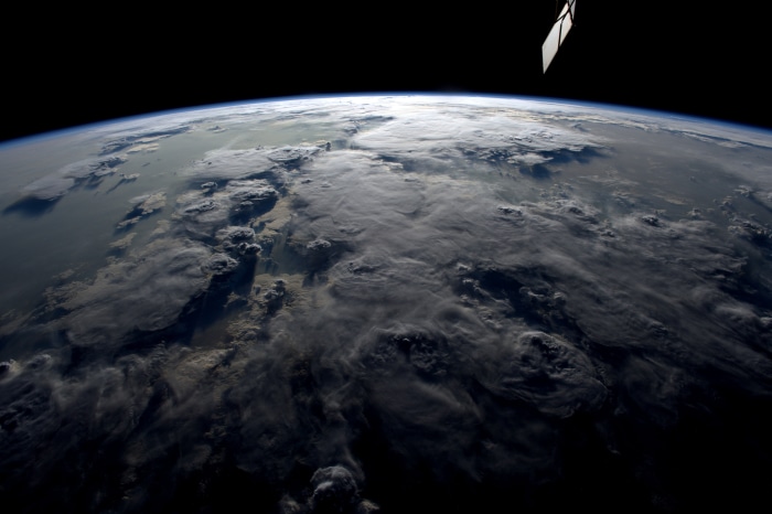 Earth from Space with Clouds and Satellite